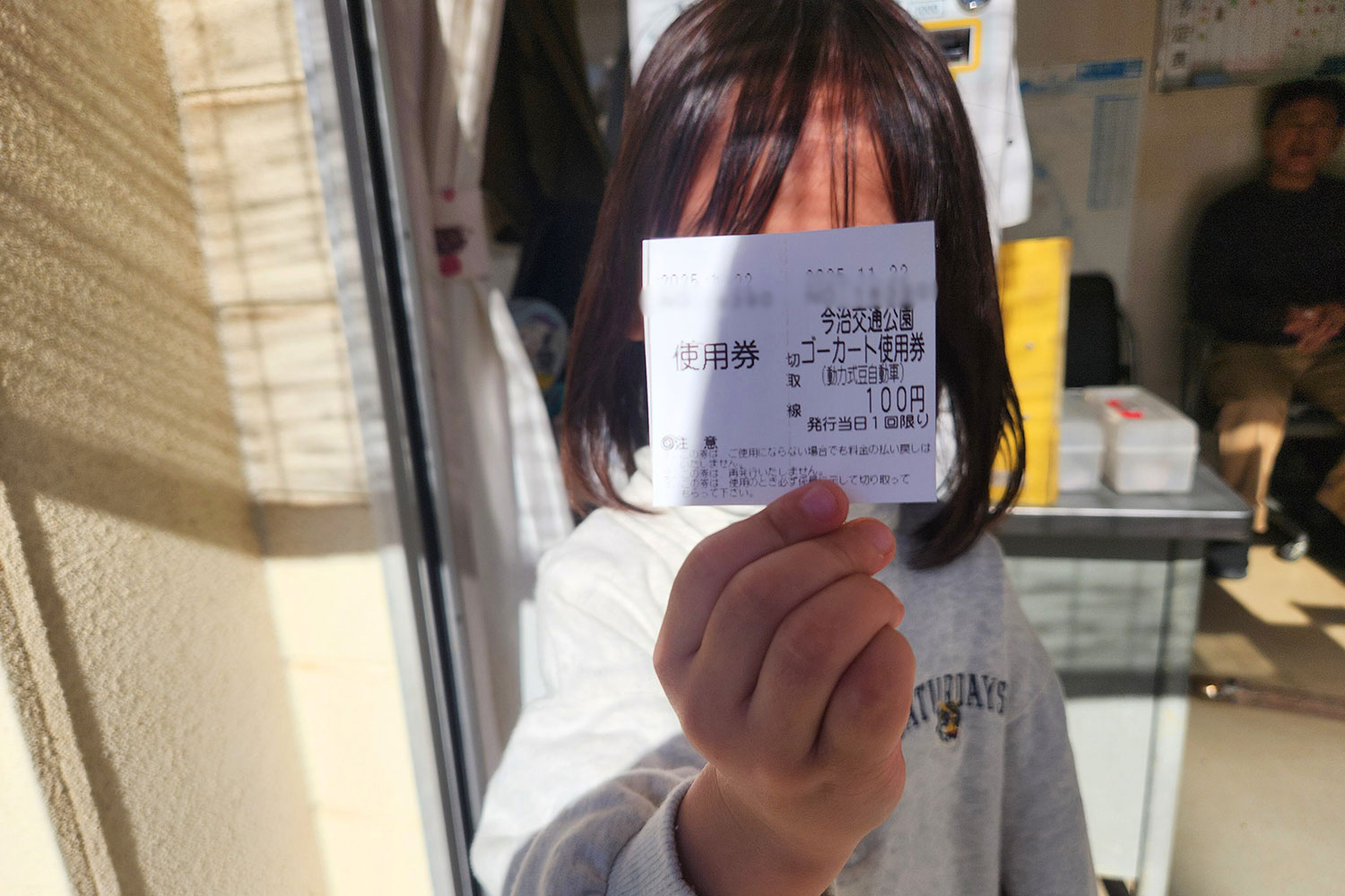 ゴーカートのチケットを持つこども